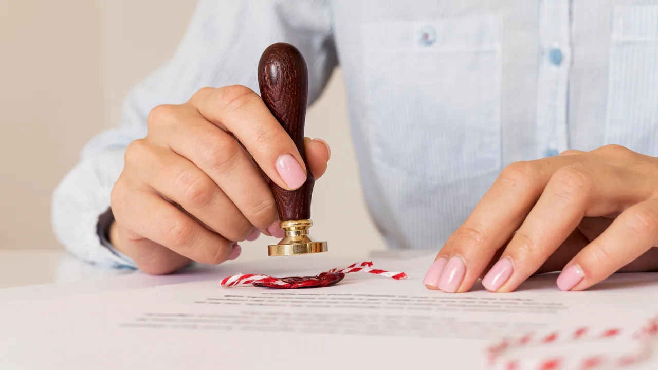 Hand plaatst een stempel op een officieel document